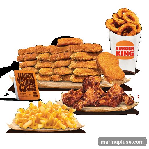 A spread of fast food items including a large stack of chicken nuggets, several pieces of fried chicken, a pile of cheese-covered fries, a cup of onion rings with the Burger King logo, and a packet of Japanese Curry Sauce.