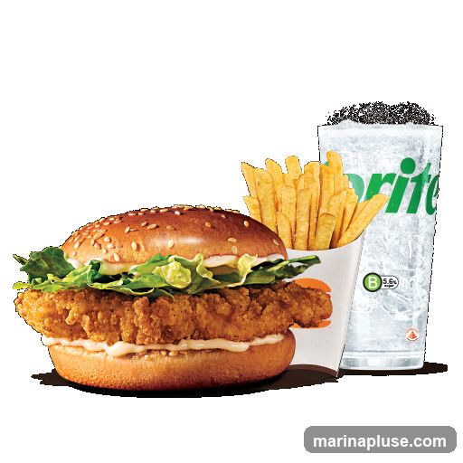 A crispy chicken sandwich with lettuce and mayonnaise on a sesame seed bun, a side of french fries, and a glass of Sprite.