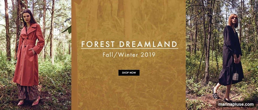 A fashion advertisement featuring two models in a forest setting. The model on the left wears a coral trench coat and patterned pants. The model on the right wears a black dress. The text "FOREST DREAMLAND" and "Fall/Winter 2019" is displayed prominently, along with a "SHOP NOW" button.