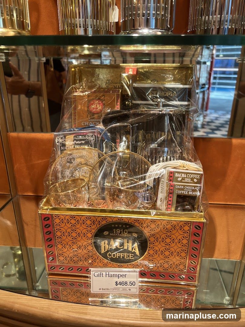 A Bacha Coffee gift hamper is displayed on a shelf. The hamper is a decorative tin filled with coffee-related items, including coffee beans, cups, and possibly crackers. A price tag indicates it is a "Gift Hamper" priced at $468.50.