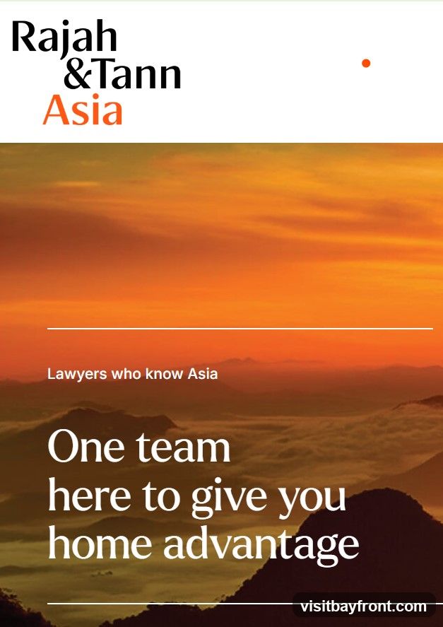 The image is an advertisement for Rajah & Tann Asia, a law firm. It features the company logo at the top, followed by a scenic background of mountains at sunset. Text overlays read "Lawyers who know Asia" and "One team here to give you home advantage."