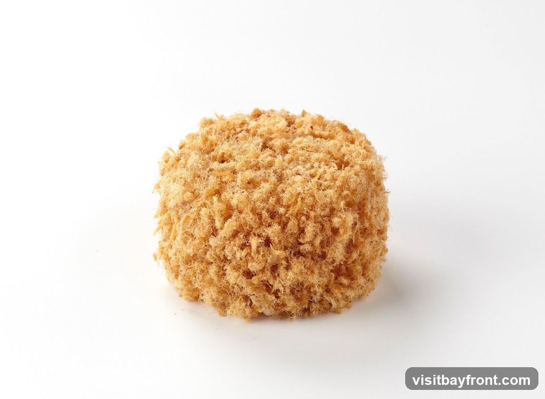 A single round object covered in golden-brown breadcrumbs, photographed against a plain white background.