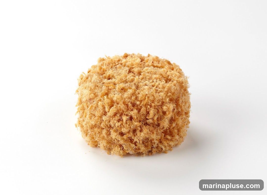 A single round object covered in golden-brown breadcrumbs, photographed against a plain white background.