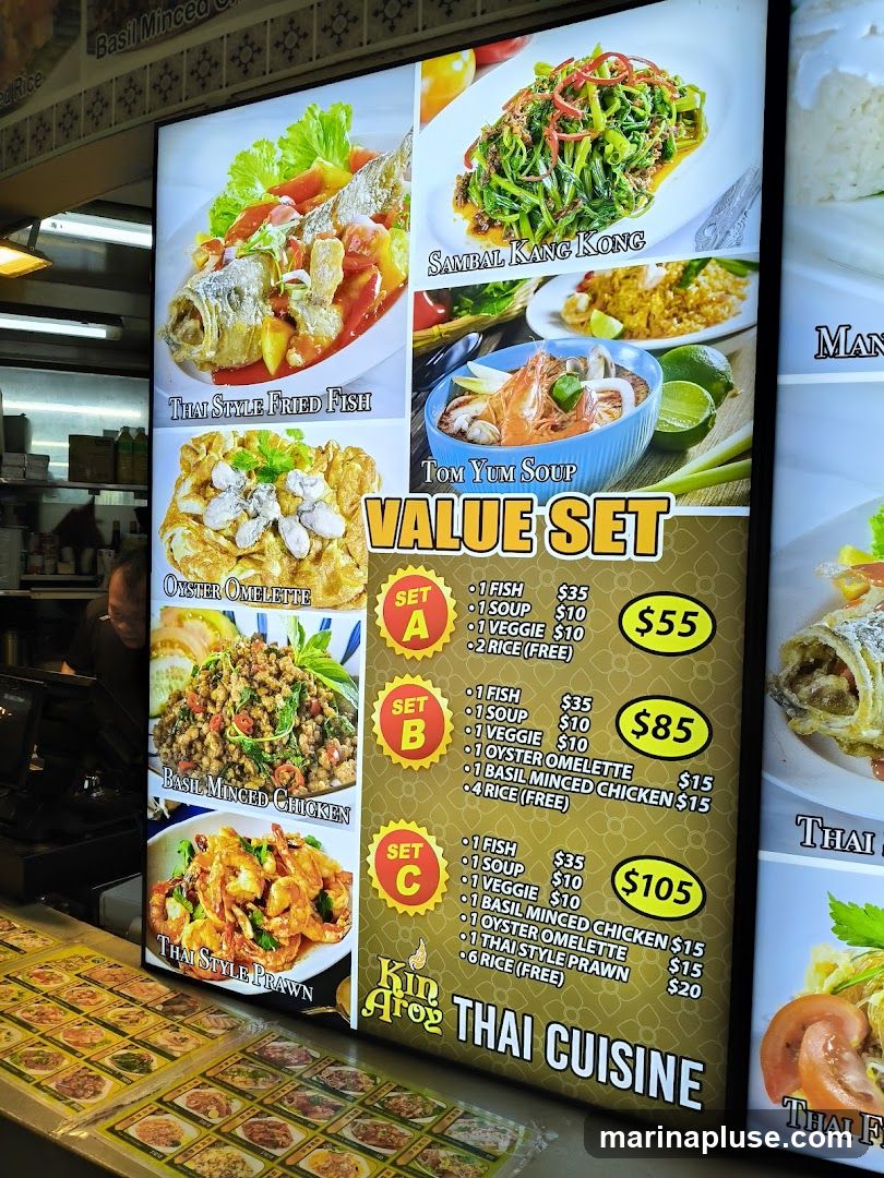 A brightly lit menu board displaying various Thai dishes and value sets.