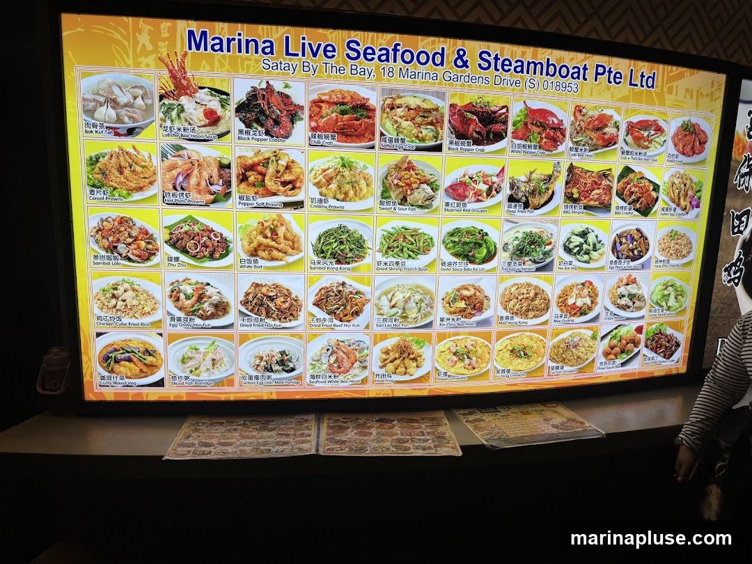 A digital menu board displaying various seafood and other dishes with images and names.
