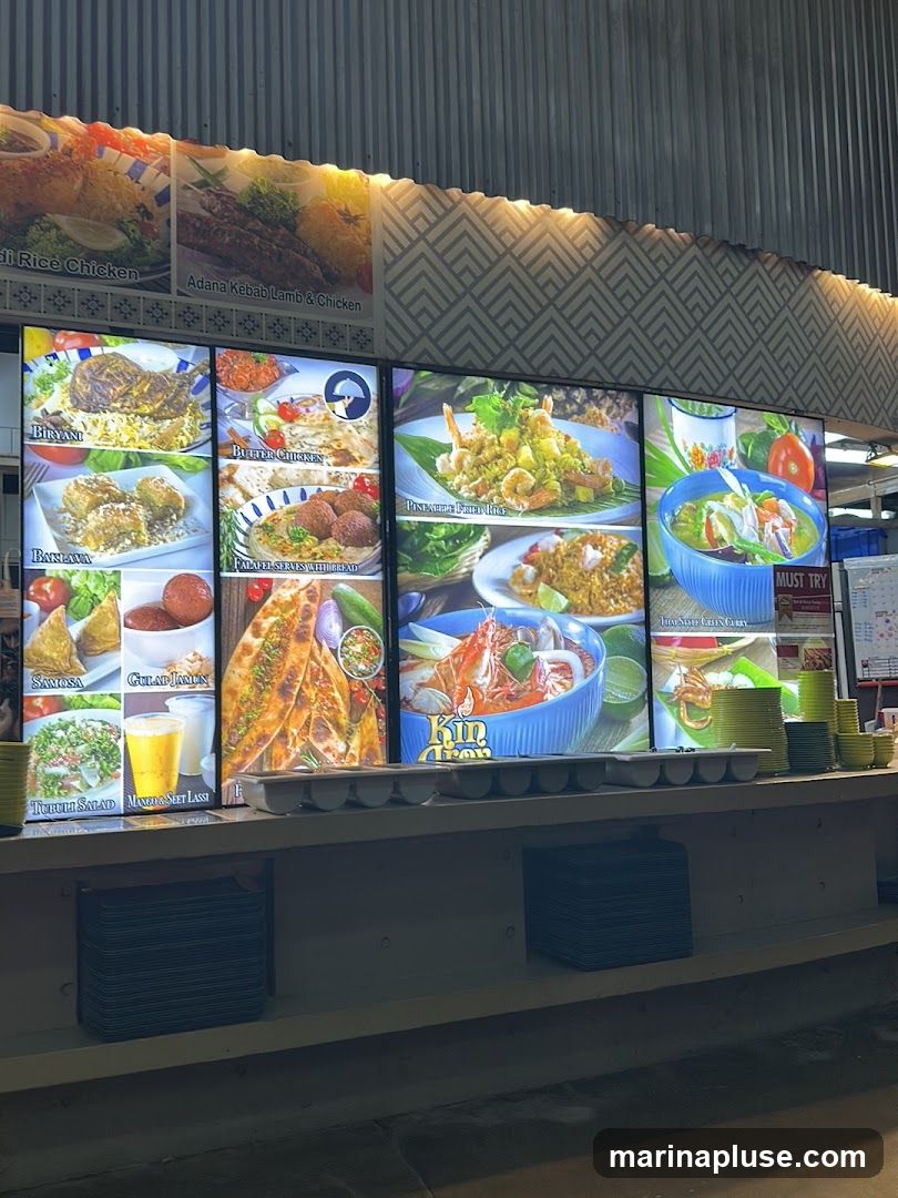 A brightly lit menu board displaying various dishes with images and text.