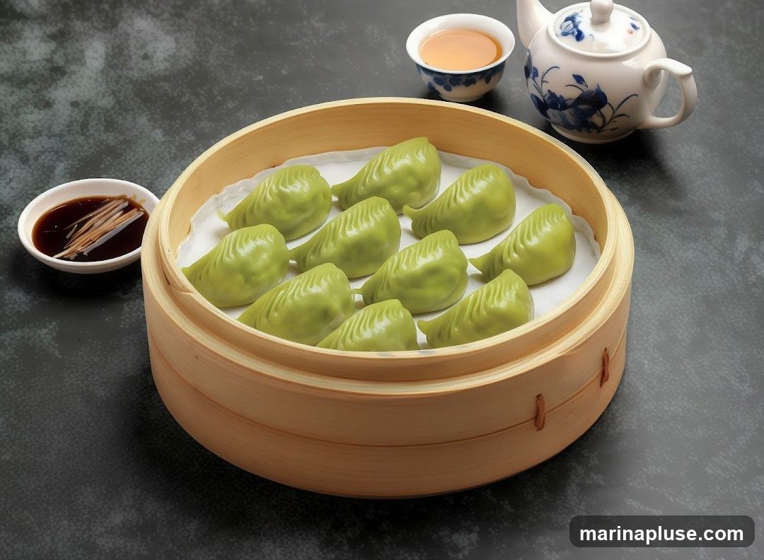A bamboo steamer filled with ten green dumplings, served with a small dish of soy sauce and ginger, and a cup of tea with a teapot.