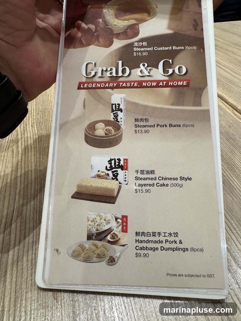 A menu featuring steamed buns, layered cake, and dumplings for takeaway.