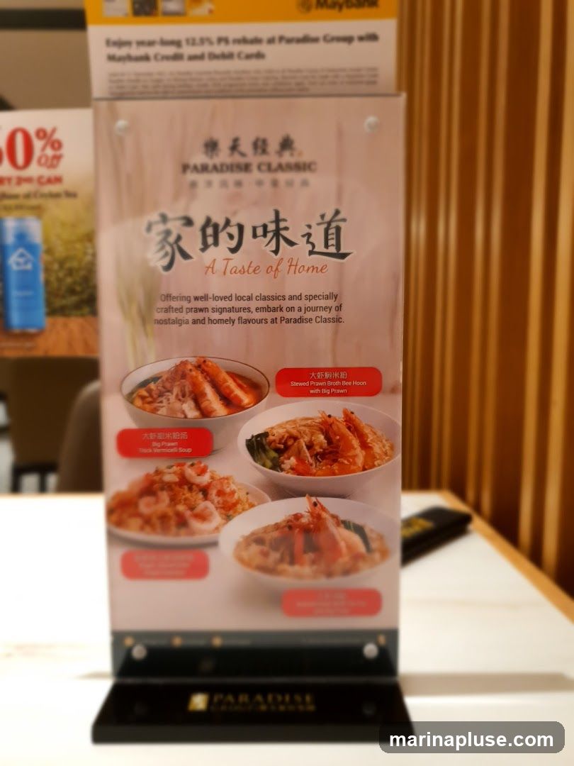 A menu featuring prawn dishes from Paradise Classic, with the tagline 'A Taste of Home'. It highlights well-loved local classics and specially crafted prawn signatures.