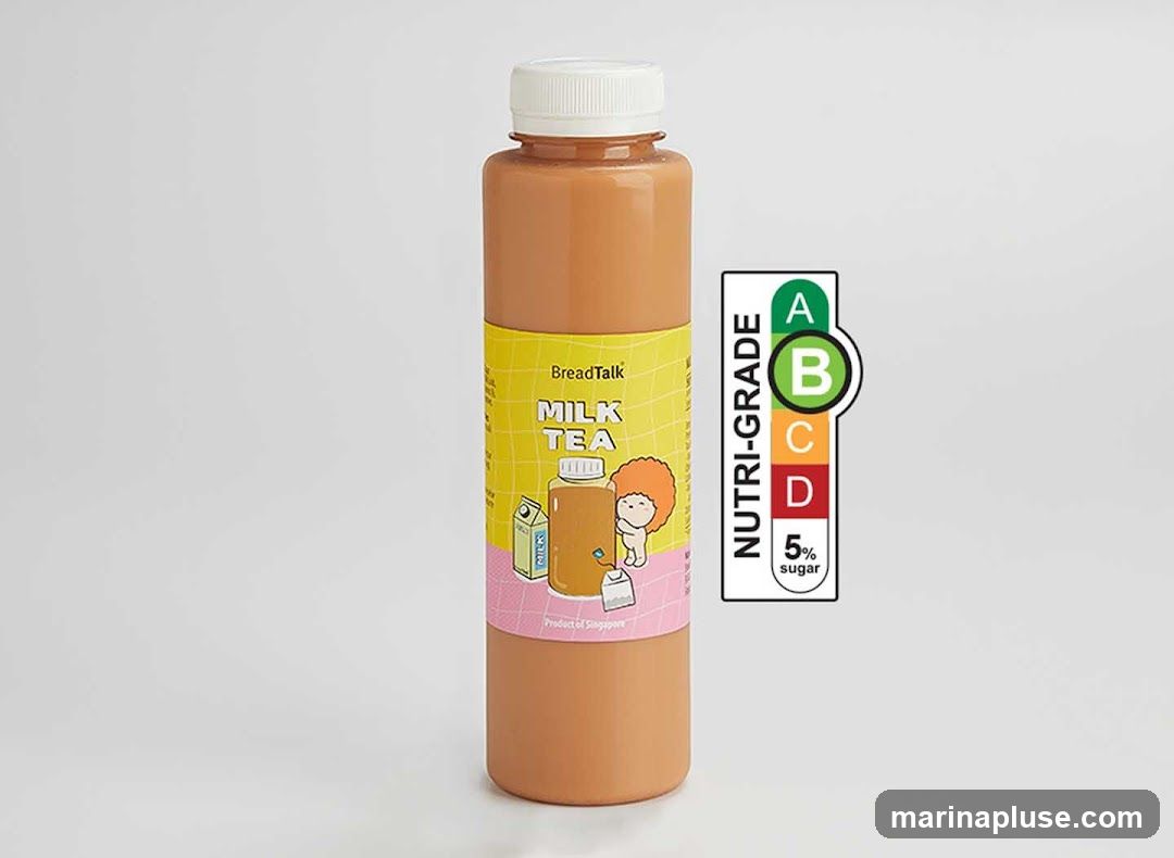 A single bottle of milk tea with a yellow label featuring the BreadTalk logo and cartoon illustration. The bottle has a white cap and contains an orange-brown liquid. To the right is a Nutri-Grade sticker indicating 'B' grade with 5% sugar.