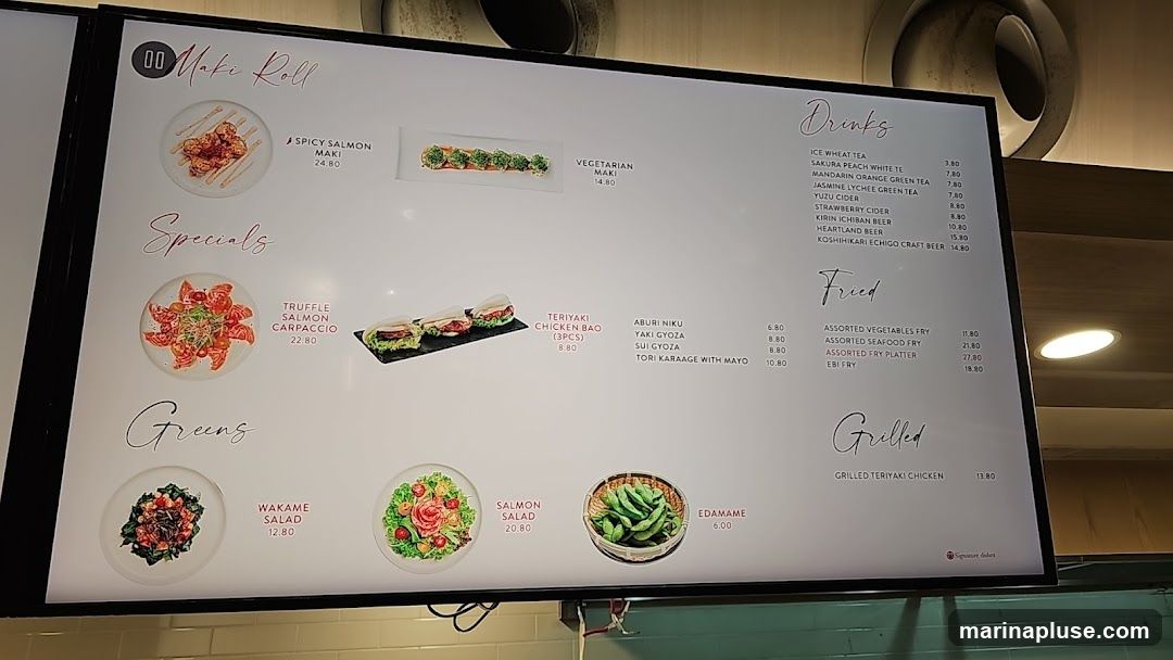 A digital menu board displaying various Japanese dishes and drinks.