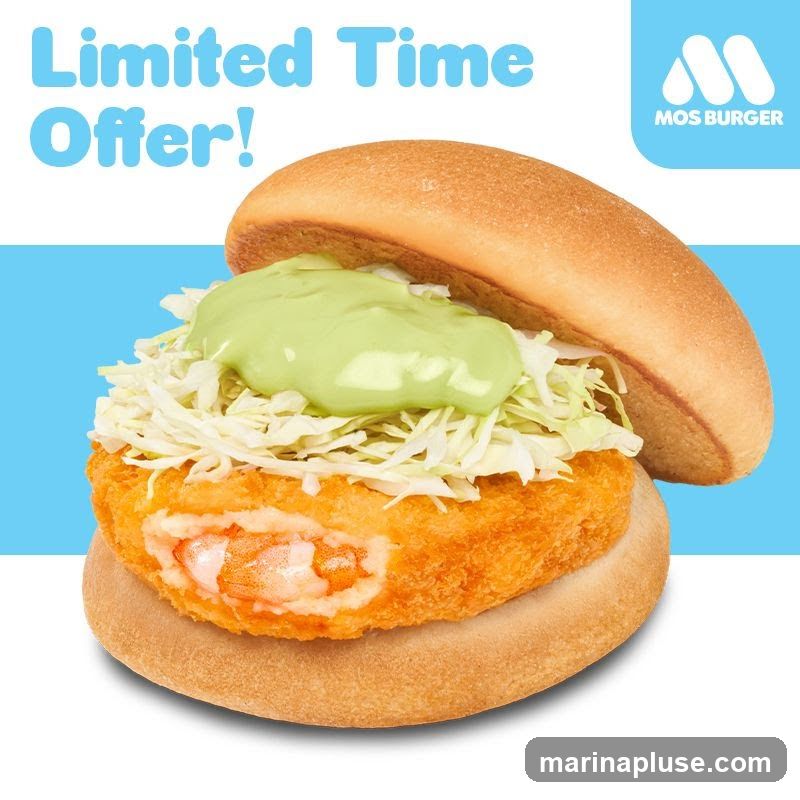 A close-up image of a burger with a crispy fried patty, shredded cabbage, and a green sauce, presented as a limited-time offer from Mos Burger.