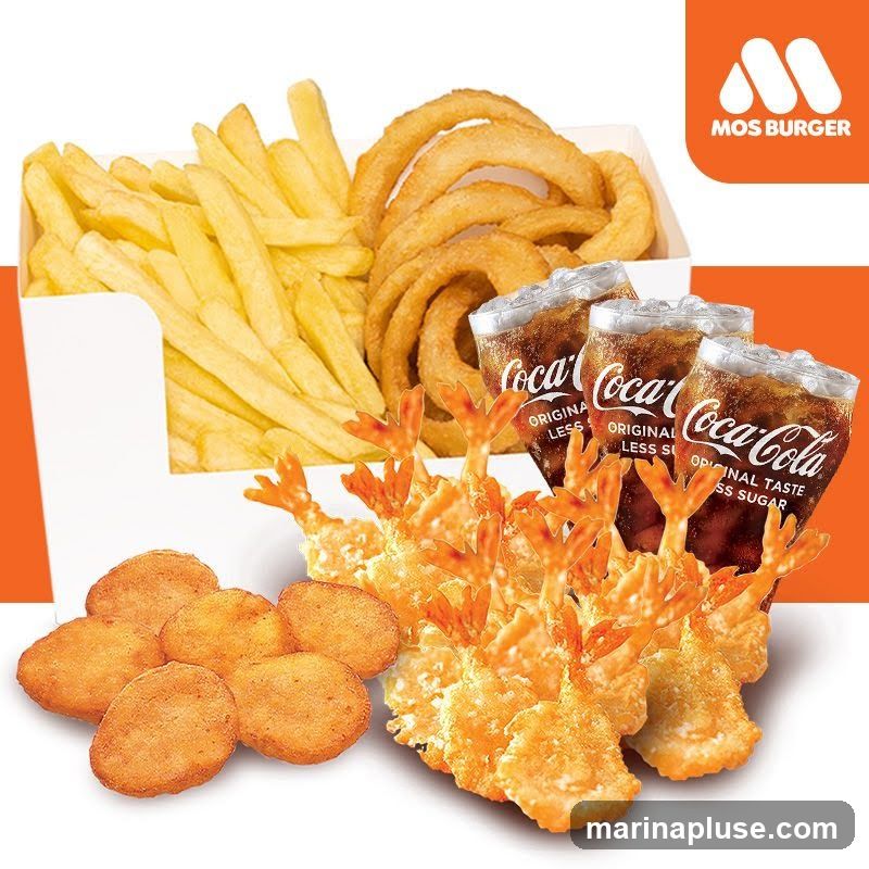 A selection of fried foods and Coca-Cola drinks from Mos Burger. The meal includes french fries, onion rings, chicken nuggets, and fried shrimp. Three glasses of Coca-Cola, labeled as 'Original Taste Less Sugar', are also visible. The Mos Burger logo is present in the upper right corner.