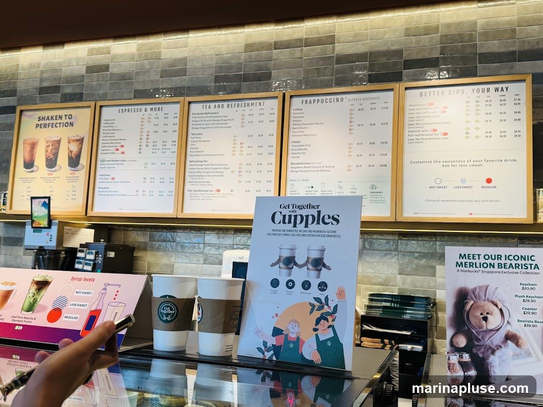 A menu board displaying various coffee and tea beverages, Frappuccinos, and other drinks. It also features a section on customizing drink sweetness and a promotion for an iconic Merlion Bearista collection.