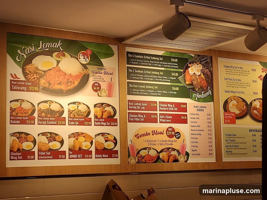 A menu board displaying various Nasi Lemak dishes, sets, sides, and beverages.