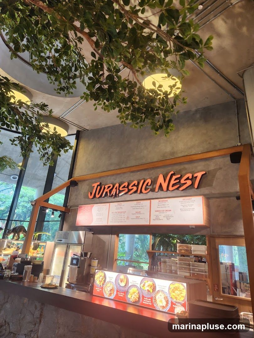 A menu board for Jurassic Nest, featuring gourmet coffee, all-day breakfast, pasta, sides, salad, soup, beverage, and dessert options. Below the main menu are images of various dishes.