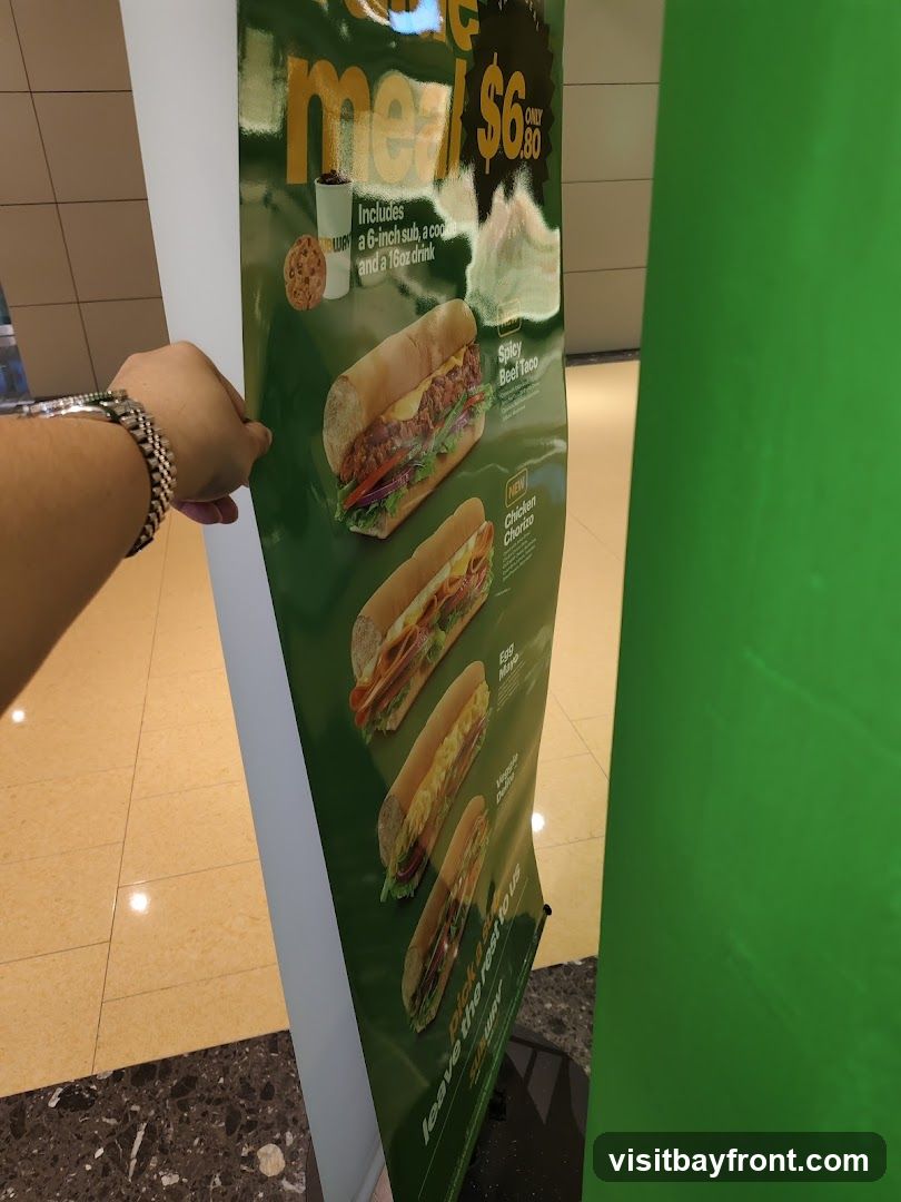 A promotional poster for Subway featuring a meal deal that includes a 6-inch sub, a cookie, and a 16oz drink for $6.80. The poster displays images of several subs, including Spicy Beef Taco, Chicken Chorizo, Egg Mayo, and Veggie Delight.
