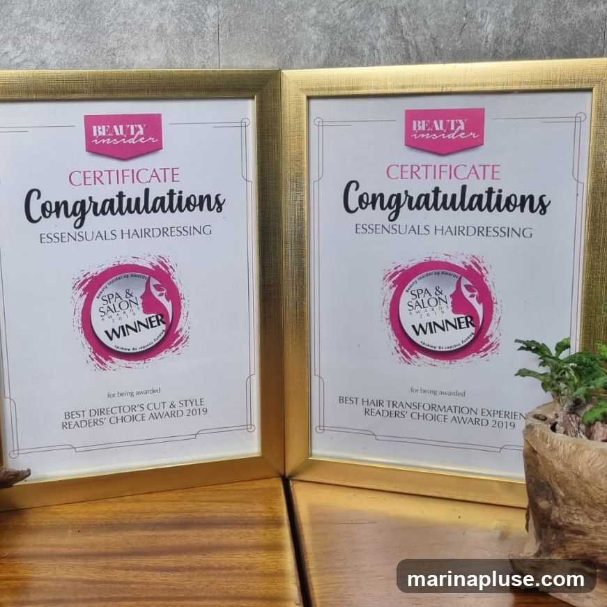 Two framed certificates congratulating Essensuals Hairdressing for winning awards in 2019. One is for Best Director's Cut & Style, and the other for Best Hair Transformation Experience, both from the Readers' Choice Awards by Beauty Insider.