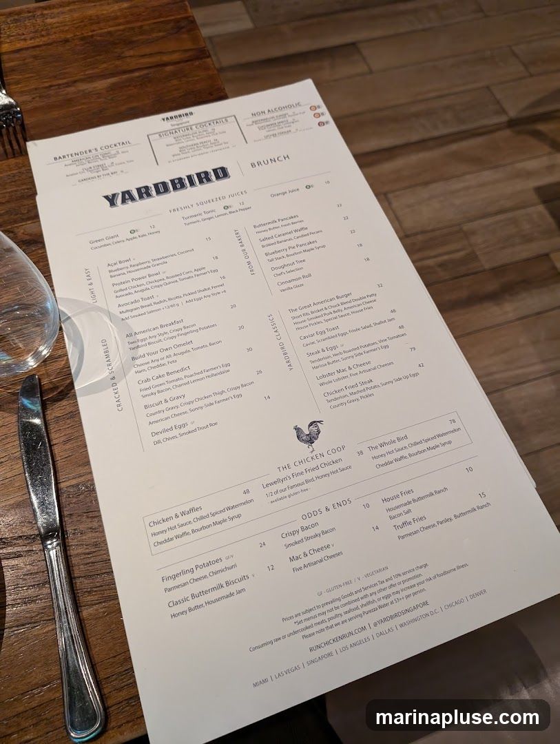 A brunch menu from Yardbird featuring cocktails, non-alcoholic drinks, freshly squeezed juices, and a variety of dishes categorized under "From Our Bakery", "Yardbird Classics", "The Chicken Coop", and "Odds & Ends".