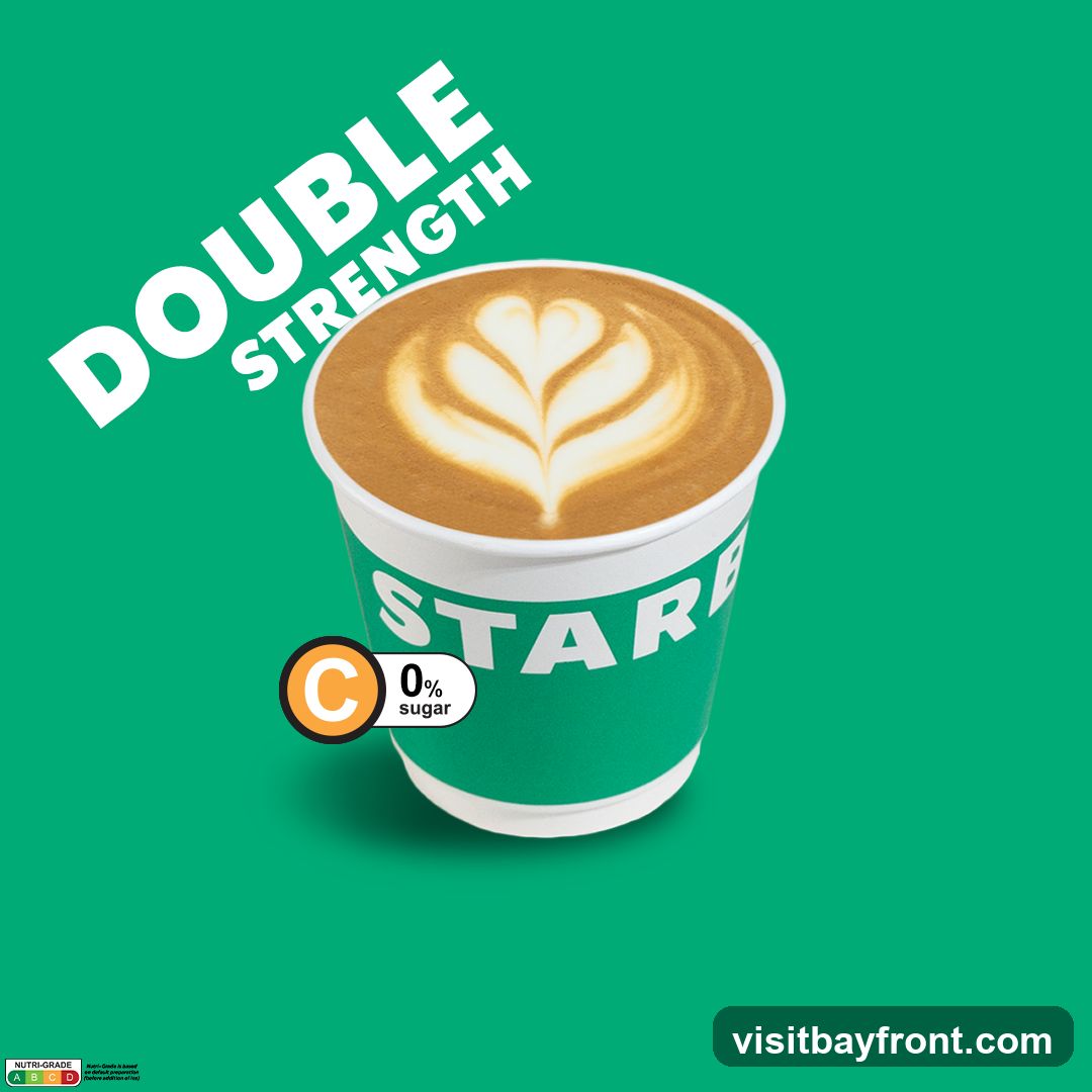 A cup of coffee with latte art, labeled as "Double Strength" and "0% sugar". The cup has the word "STAR" visible. A Nutri-Grade label is present at the bottom left.