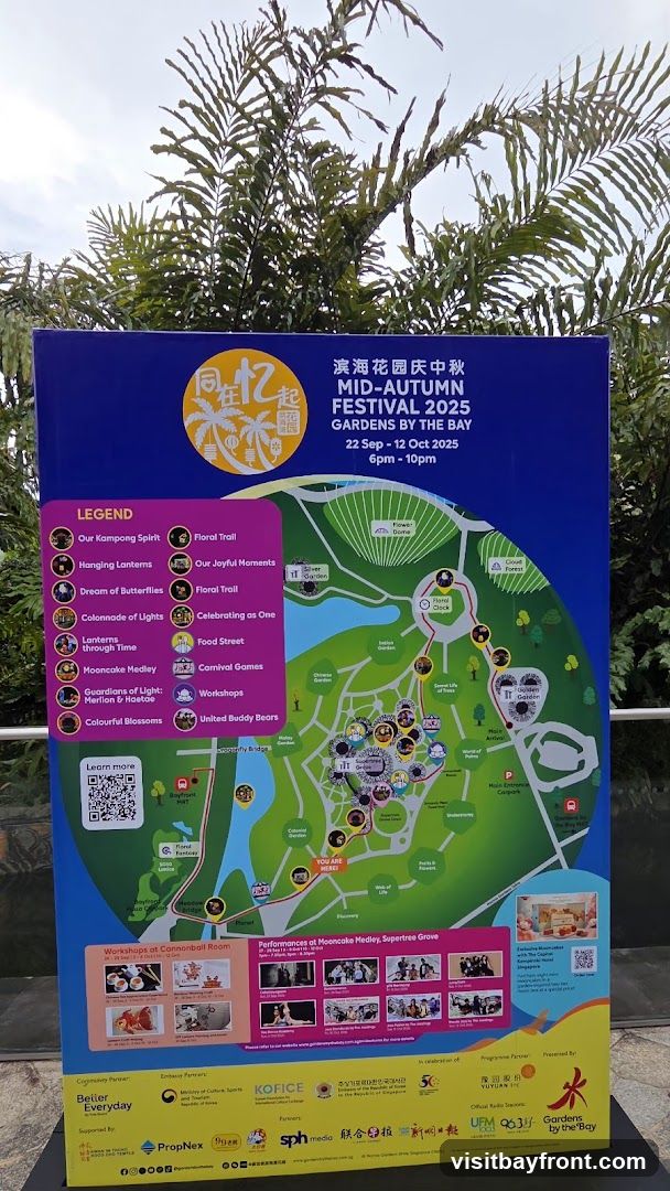 A map of Gardens by the Bay for the Mid-Autumn Festival 2025, detailing various attractions, performances, and workshops. The map includes a legend with activities such as 'Our Kampong Spirit', 'Hanging Lanterns', 'Dream of Butterflies', 'Colonnade of Lights', 'Lanterns through Time', 'Mooncake Medley', 'Guardians of Light', 'Colourful Blossoms', 'Floral Trail', 'Our Joyful Moments', 'Celebrating as One', 'Food Street', 'Carnival Games', 'Workshops', and 'United Buddy Bears'. It also shows performance schedules and workshop details.