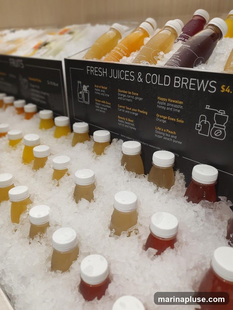 Bottled juices and cold brews displayed on ice.