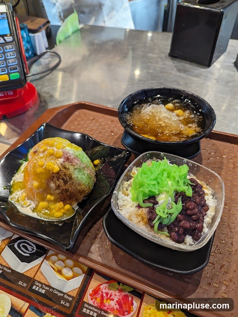 A tray holds three bowls of dessert. One is a shaved ice dessert with green jelly noodles and red beans. Another is a ball-shaped dessert topped with corn and drizzled with sauce. The third is a bowl of shaved ice with corn and syrup. A menu with images and prices of desserts is visible at the bottom of the tray.