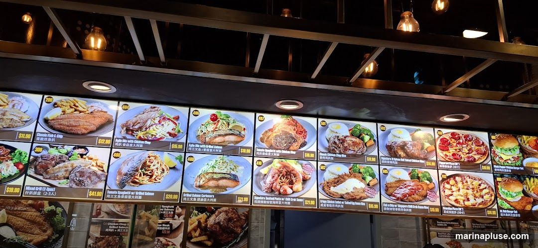 A brightly lit menu board displaying various food items with images and prices.