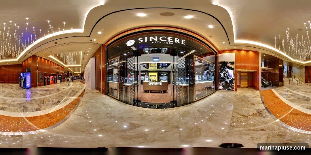 The exterior of a Sincere watch store with its name and establishment date visible above the entrance. The store features large glass windows displaying watches and jewelry inside. The surrounding area appears to be a well-lit, upscale interior with marble flooring and decorative lighting.