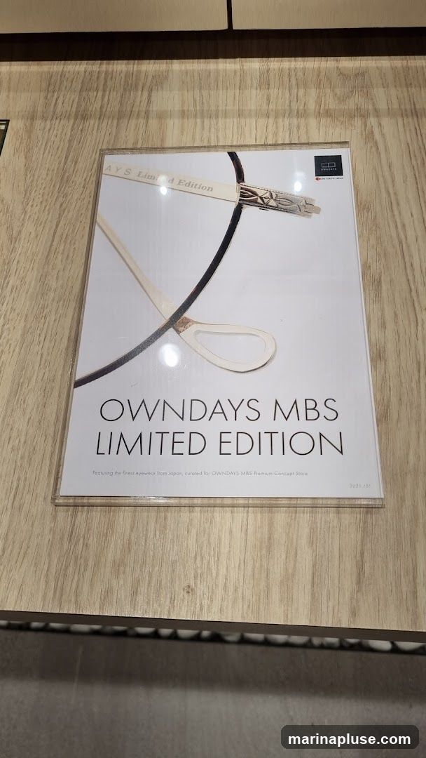 A promotional flyer for OWNDAYS MBS Limited Edition eyewear, featuring a close-up image of a pair of glasses. The text indicates that the eyewear is from Japan and curated for the OWNDAYS MBS Premium Concept Store.