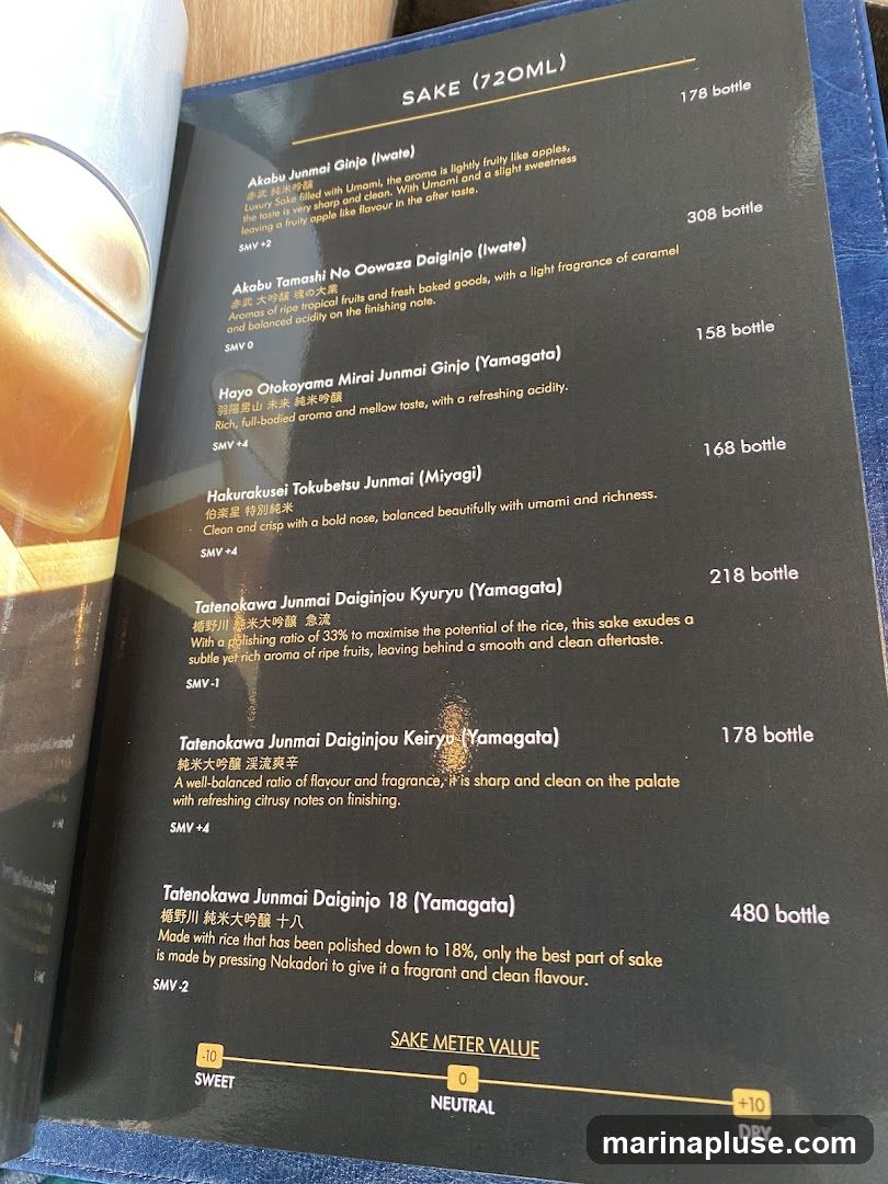 A menu listing various types of sake with descriptions and prices. Includes a Sake Meter Value scale from Sweet to Dry.