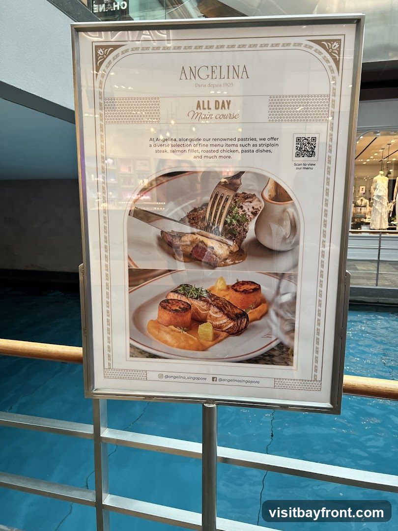 A framed menu board for Angelina, a Parisian establishment since 1903, advertising their All Day Main Course offerings. The menu highlights a selection of fine dishes including striploin steak, salmon fillet, roasted chicken, and pasta dishes, in addition to their renowned pastries. The board features images of two main courses and a QR code to scan for the full menu. Social media handles for Angelina Singapore are also visible.