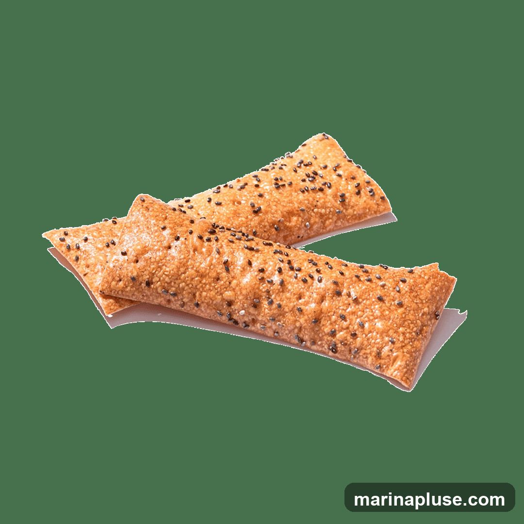 Two golden-brown pastries are shown against a black background. The pastries are elongated and appear to be filled. They are sprinkled with numerous small black seeds, likely chia seeds, and possibly sesame seeds. The pastries are slightly overlapping.