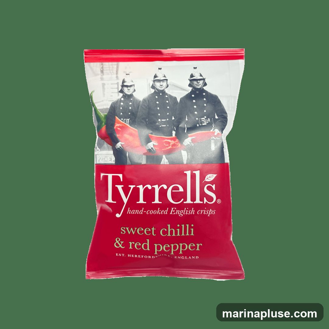 A bag of Tyrrells hand-cooked English crisps in sweet chilli and red pepper flavor. The packaging features an image of three men in historical uniforms holding red peppers. The brand name "Tyrrells" is prominently displayed, along with the flavor and "Est. Hereford, England".