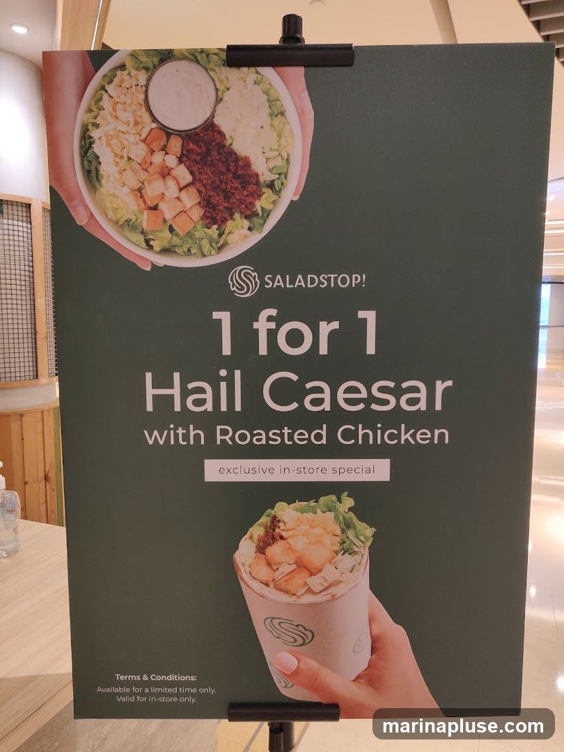 A promotional poster for Saladstop! advertising a 1 for 1 offer on their Hail Caesar salad with Roasted Chicken. The poster features images of a salad and a wrap, and states that the offer is an exclusive in-store special, available for a limited time only.