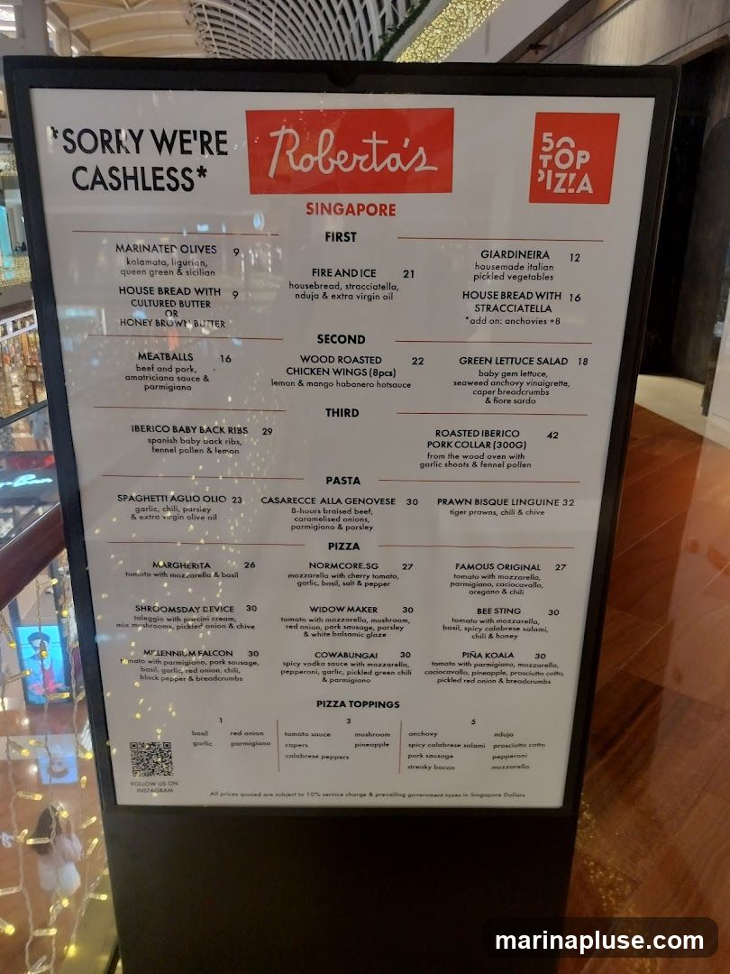A menu for Roberta's Singapore, featuring pizzas, pastas, and other dishes. It also states 'Sorry we're cashless'.