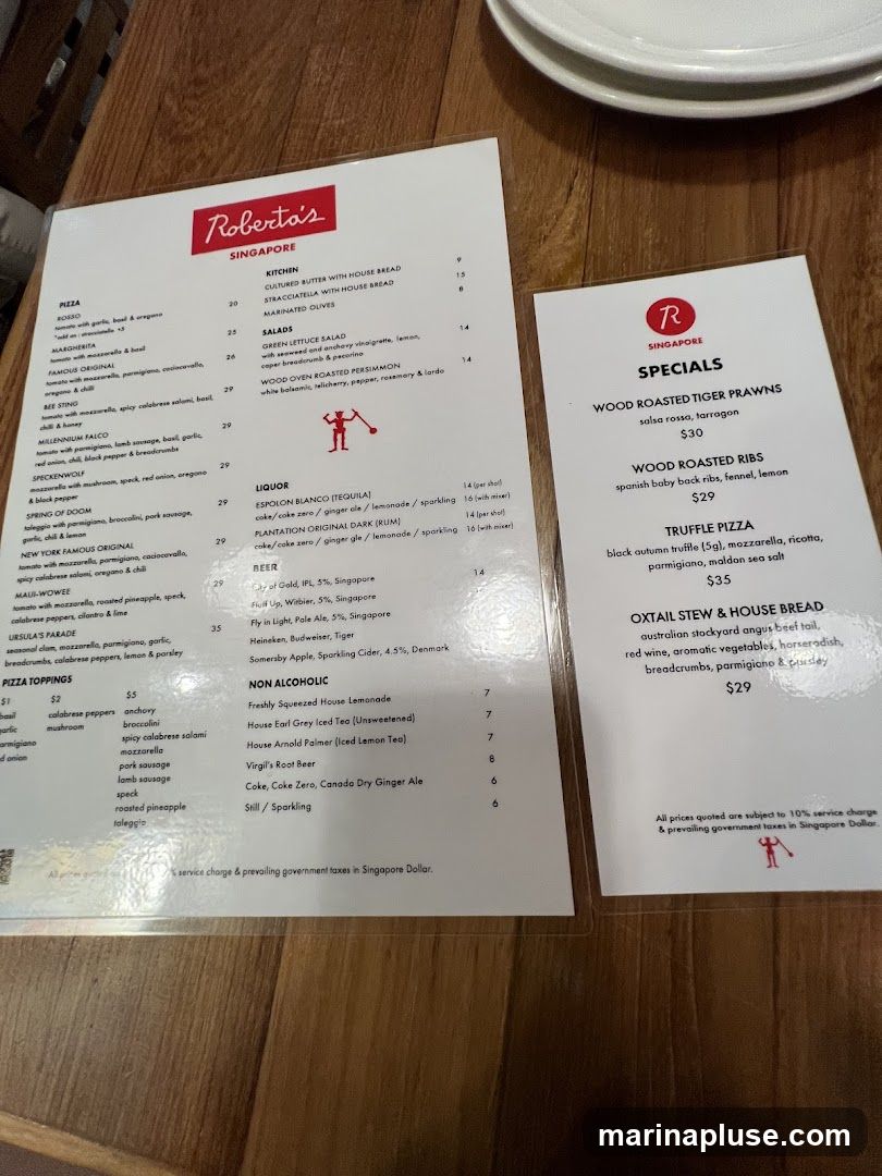 A menu from Roberta's Singapore featuring pizzas, salads, liquor, beer, non-alcoholic drinks, and specials.