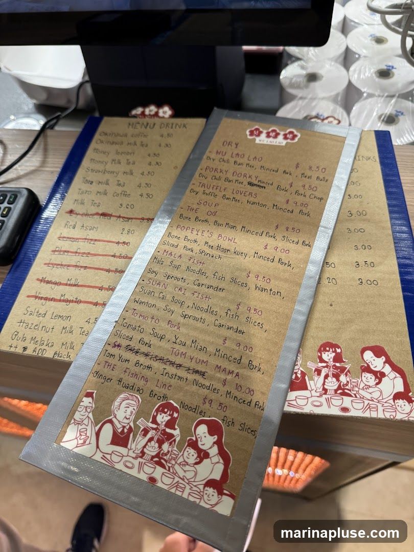 A menu with two sections: DRINK and other food items. The DRINK section lists various milk teas, lemonades, and coffees. The other section lists noodle dishes and soups with ingredients and prices.