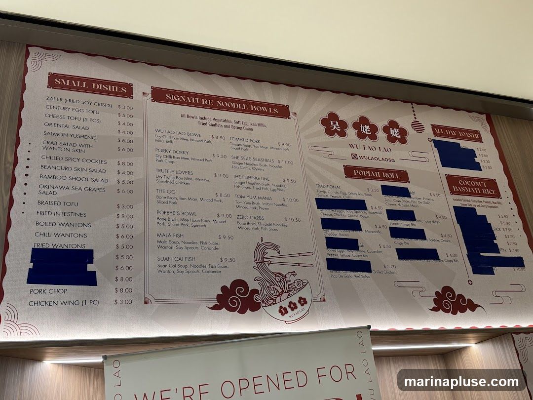 A menu board with sections for Small Dishes, Signature Noodle Bowls, All Day Toastie, Popiah Roll, and Coconut Basmati Rice.