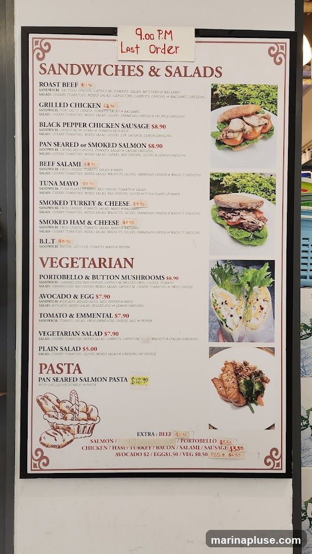 Menu board with sandwiches, salads, and pasta options. Last order at 9:00 PM.