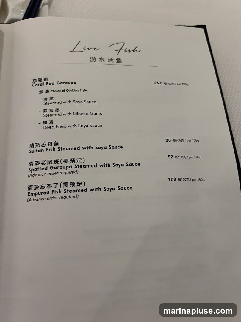 Menu section for live fish dishes with cooking style options and prices per 100g.