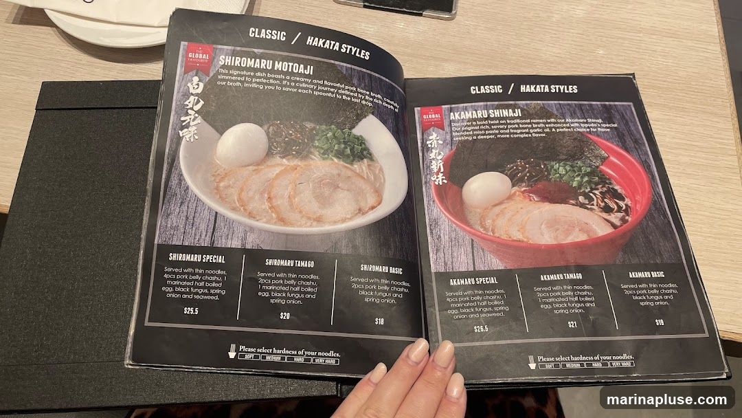 Menu featuring two styles of ramen: Shiromaru Motoaji and Akamaru Shinaji, with various options for each.