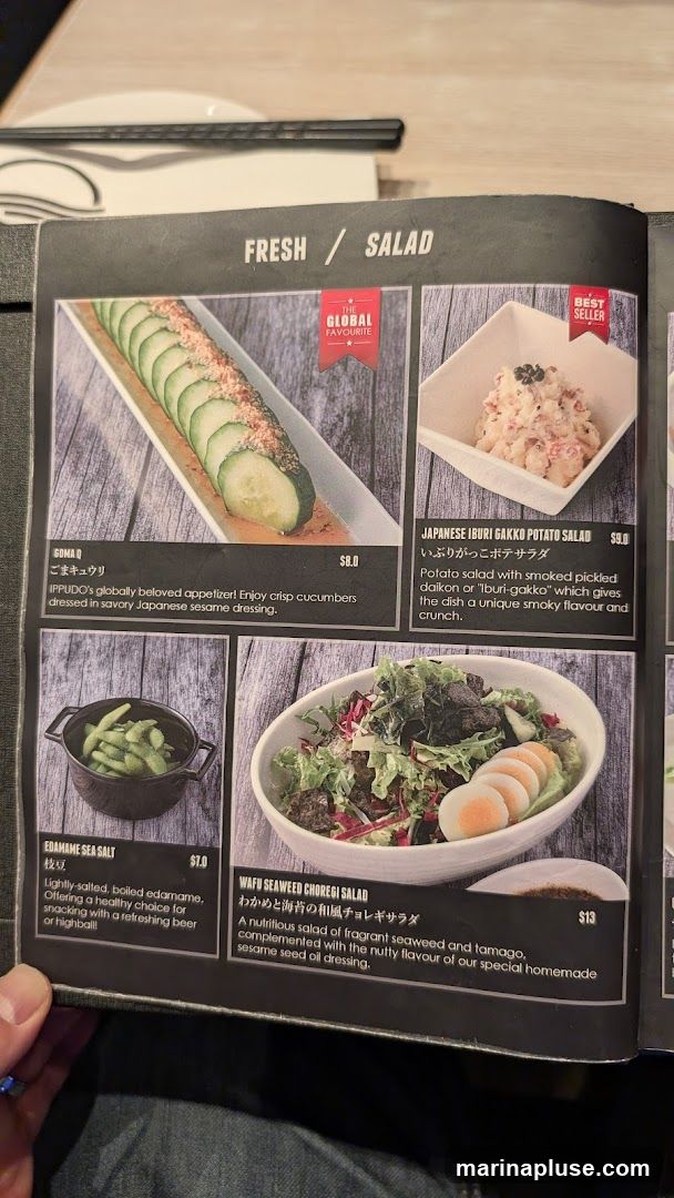 A menu page featuring four salad options: Goma Q, Japanese Iburi Gakko Potato Salad, Edamame Sea Salt, and Wafu Seaweed Choregi Salad.