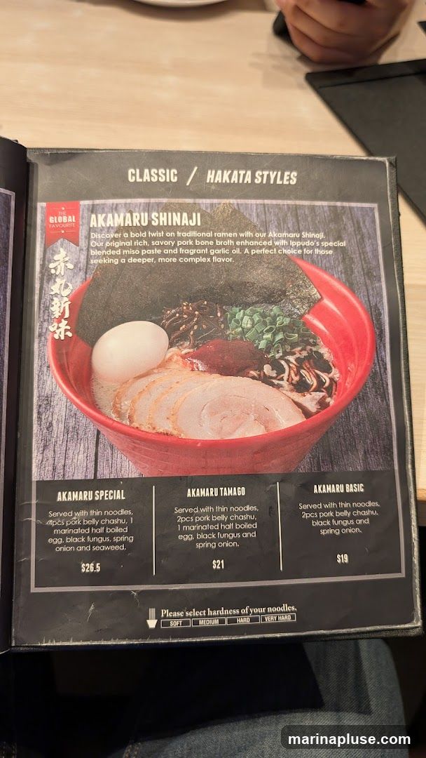 Menu featuring Hakata style ramen with descriptions and prices for Akamaru Special, Akamaru Tamago, and Akamaru Basic. Includes options for noodle hardness.