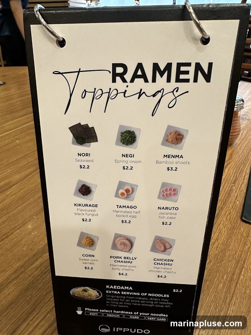 A menu displaying various ramen toppings with images and prices.