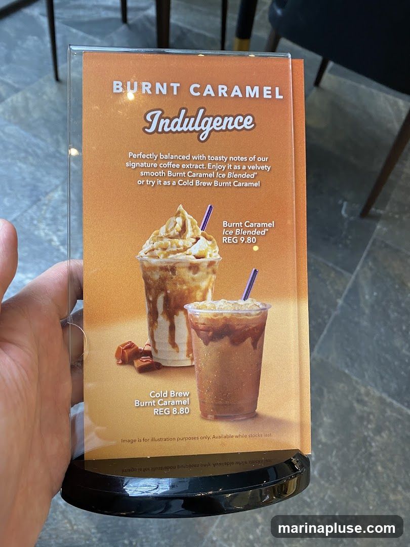 A menu displaying two burnt caramel coffee drinks. The top drink is a Burnt Caramel Ice Blended with a regular price of 9.80. The bottom drink is a Cold Brew Burnt Caramel with a regular price of 8.80. The menu also includes a description of the drinks.