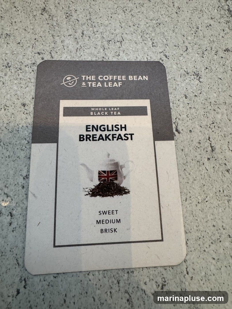 A card from The Coffee Bean & Tea Leaf brand featuring their English Breakfast whole leaf black tea. The card displays the brand logo, the tea name, an image of a teapot with a Union Jack flag and a pile of tea leaves, and flavor notes: Sweet, Medium, Brisk.