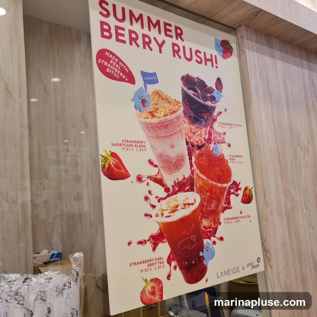 A promotional poster for a "Summer Berry Rush" drink menu, featuring four different strawberry-themed beverages. The drinks shown are Strawberry Shortcake Blend, Strawberry Cocoa, Strawberry Boba, and Strawberry Earl Grey Tea. Prices are listed for medium (M) and large (L) sizes. The poster also displays the logos of Laneige and Playmade.
