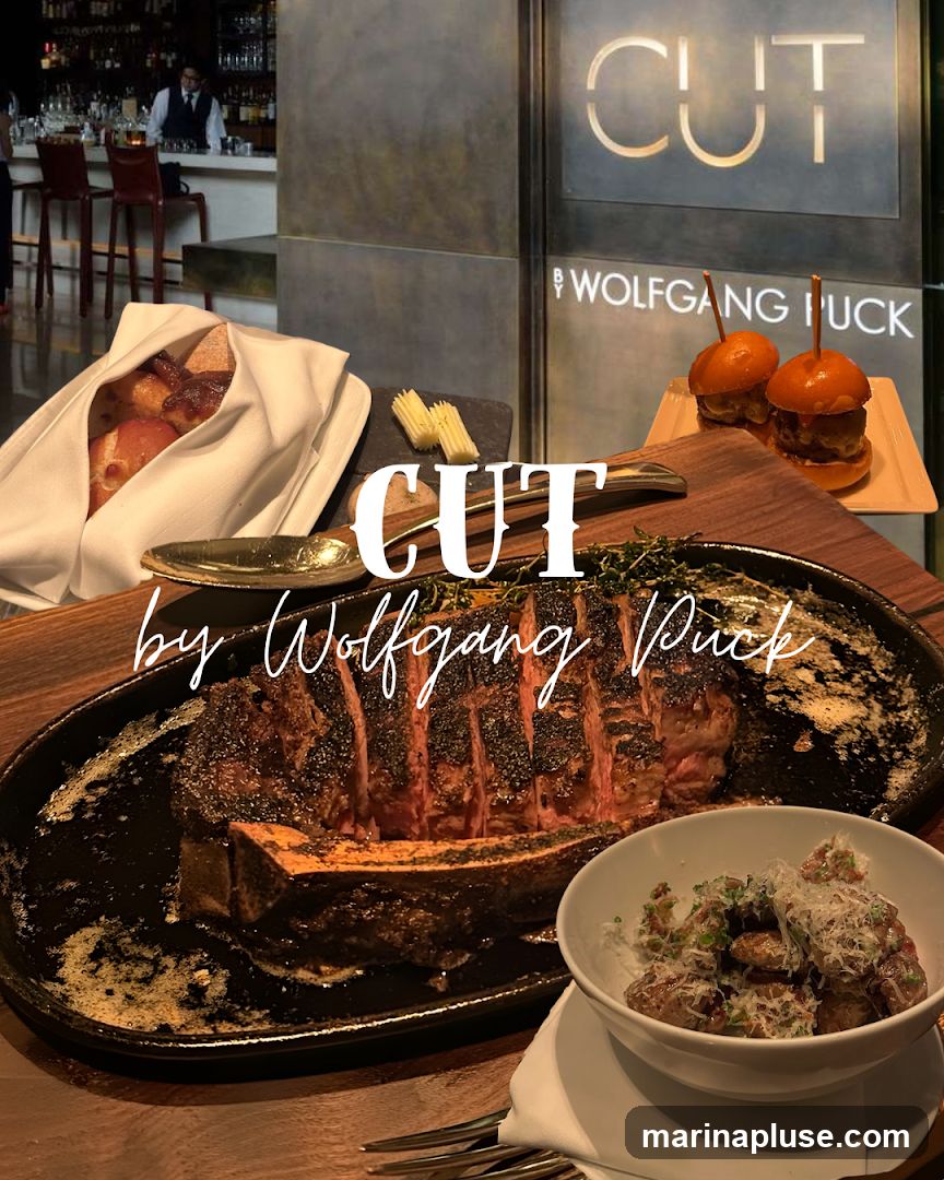 A large, sliced steak is presented on a black platter, accompanied by a bowl of potatoes and two mini burgers. The restaurant's name, "CUT by Wolfgang Puck," is overlaid on the image. In the background, a bar area with a bartender is visible.