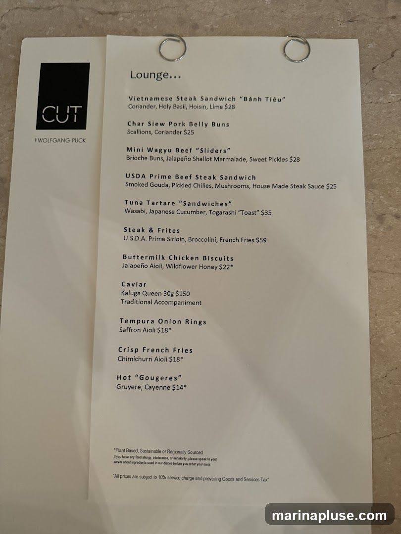 A menu from CUT by Wolfgang Puck, featuring sandwiches, appetizers, and sides.